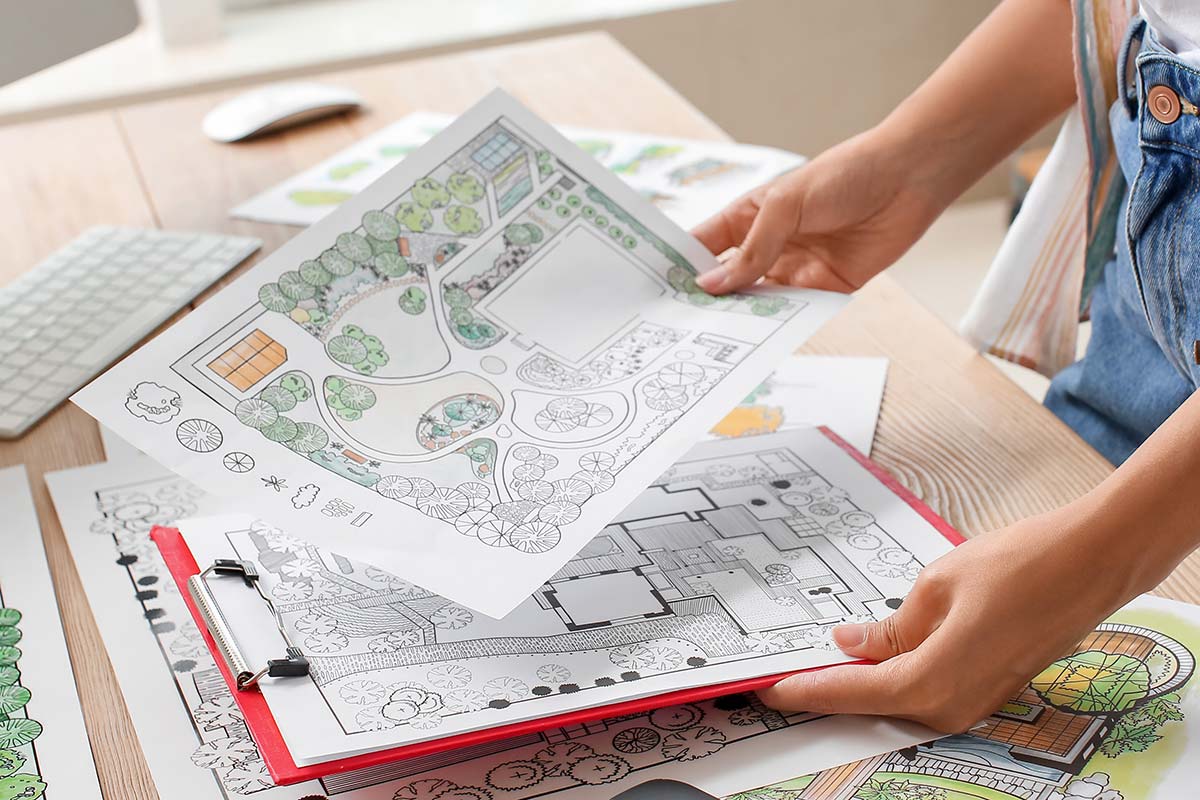 Photo showing landscape design plans in hand